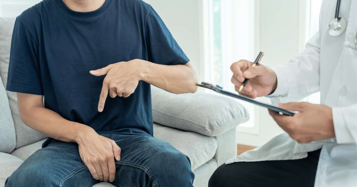 A photo of a man having penile consultation from a physician.