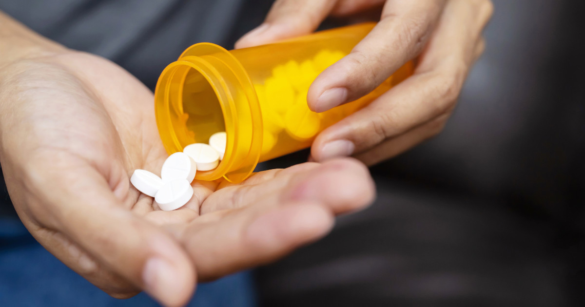 man holding a pill in his hand