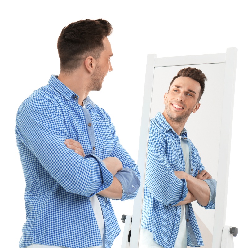 a man looking at himself in the mirror